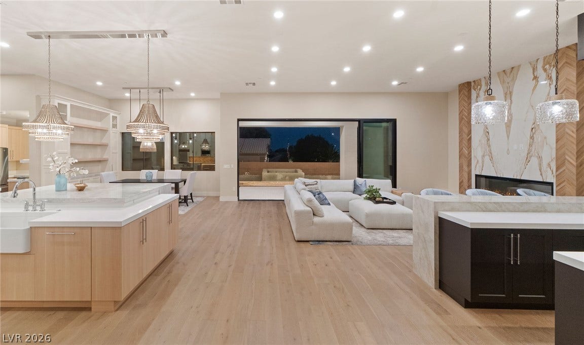 An open floorplan connects the modern kitchen directly to the spacious living area.