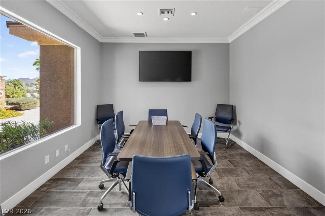 2900 Sunridge Heights Parkway, #1022, Henderson, NV 89052 Crown molding and large windows frame this versatile meeting room or office space.