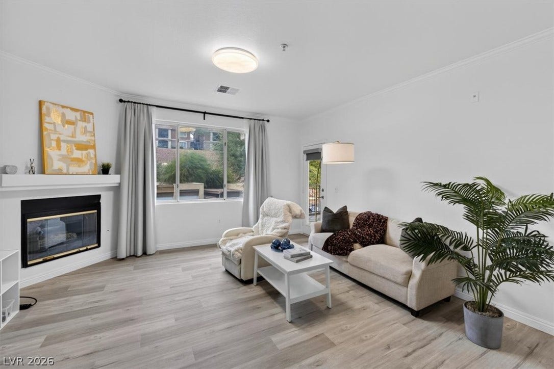 2900 Sunridge Heights Parkway, #1022, Henderson, NV 89052 A cozy wood fireplace anchors this inviting living space finished with durable wood-look flooring.