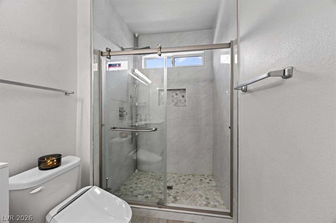 2900 Sunridge Heights Parkway, #1022, Henderson, NV 89052 Sleek glass-enclosed shower highlights this modern bathroom space featuring clean architectural lines.