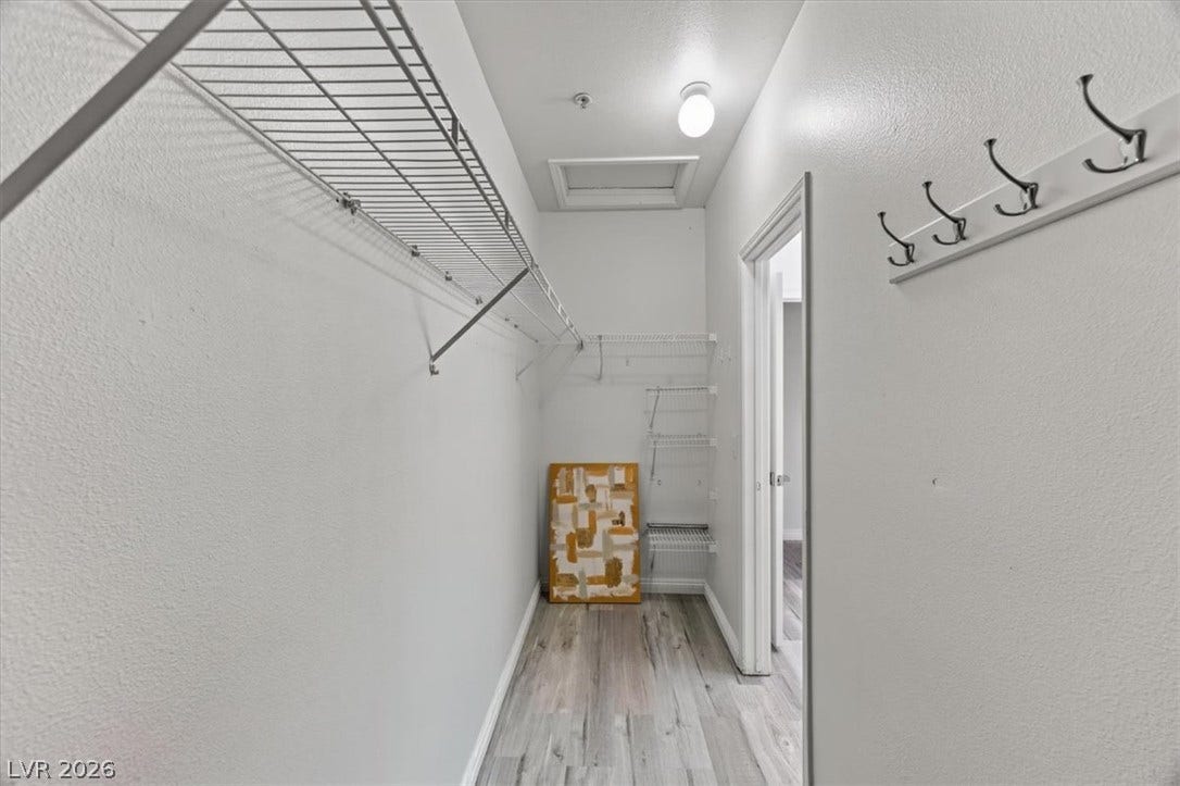 2900 Sunridge Heights Parkway, #1022, Henderson, NV 89052 A spacious walk-in closet includes durable wire shelving and wood-look flooring.