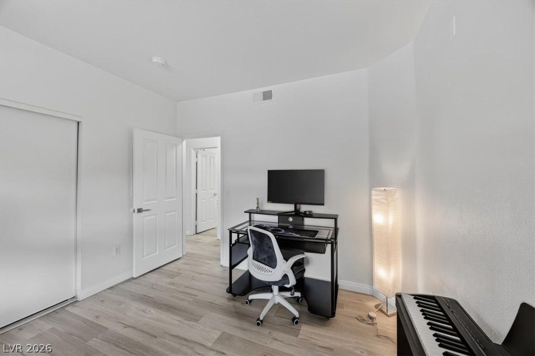2900 Sunridge Heights Parkway, #1022, Henderson, NV 89052 Smooth wood-look flooring and crisp white walls define this versatile home office space.
