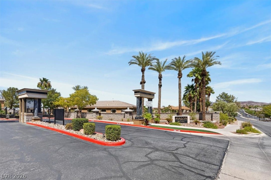 2900 Sunridge Heights Parkway, #1022, Henderson, NV 89052 Palm trees flank a secure, gated entrance that welcomes residents home.