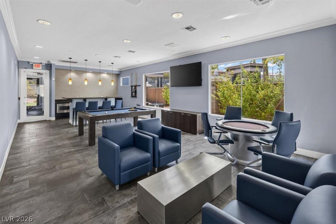 2900 Sunridge Heights Parkway, #1022, Henderson, NV 89052 Clean tile flooring and crown molding highlight this modern recreational lounge with large picture windows.
