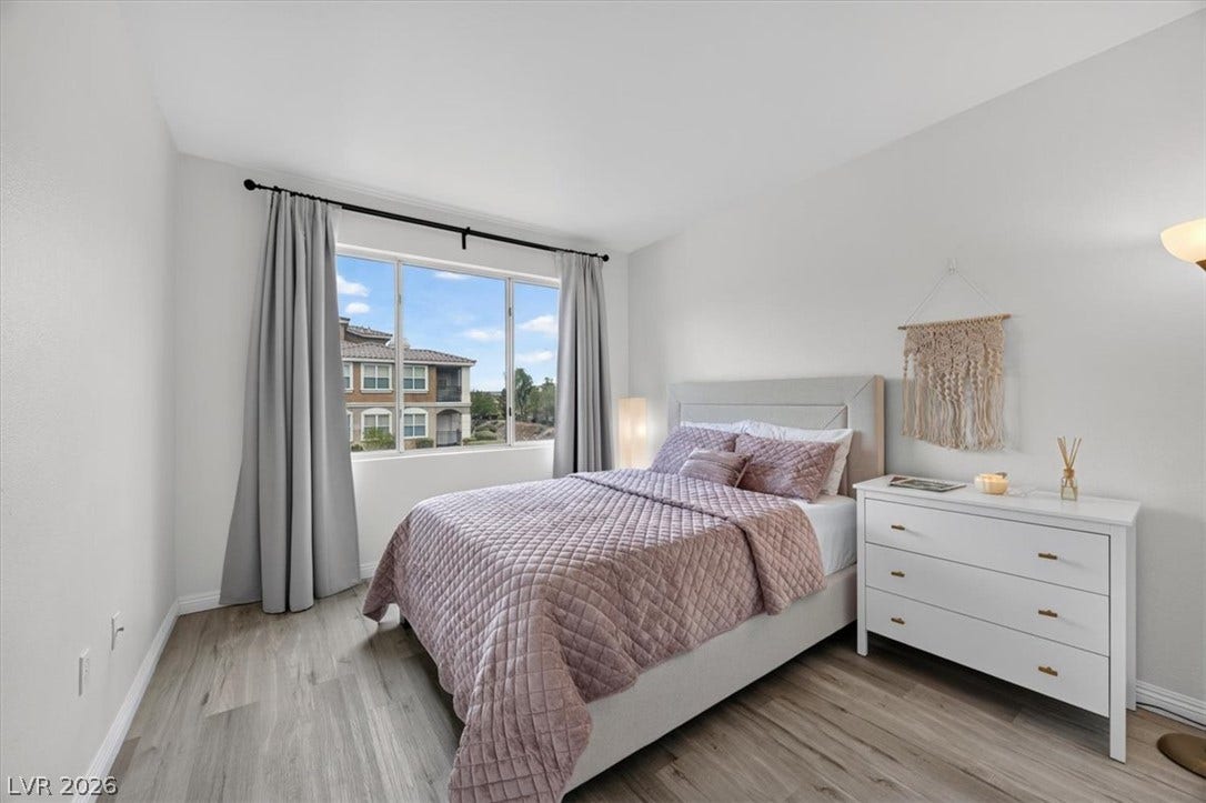 2900 Sunridge Heights Parkway, #1022, Henderson, NV 89052 Natural light pours through a large window, highlighting smooth wood flooring and clean lines.