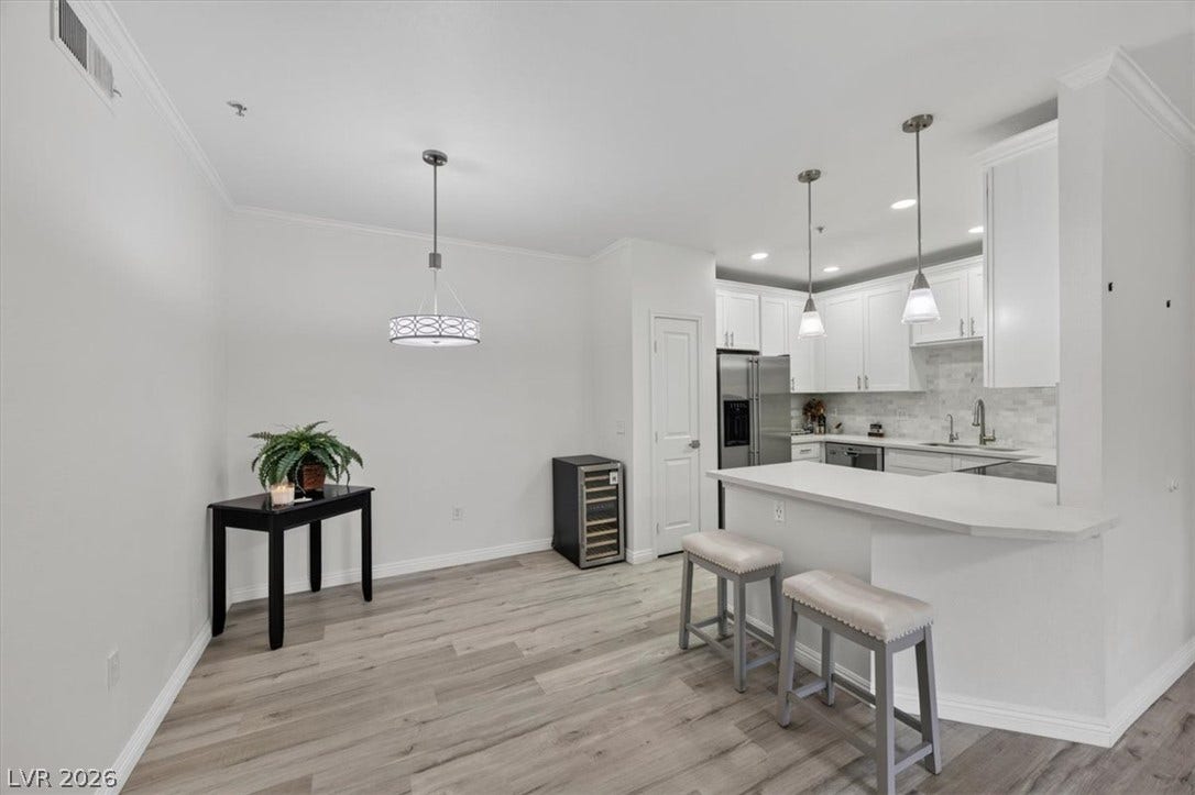 2900 Sunridge Heights Parkway, #1022, Henderson, NV 89052 Plank flooring runs from the dining area to a breakfast bar kitchen layout.