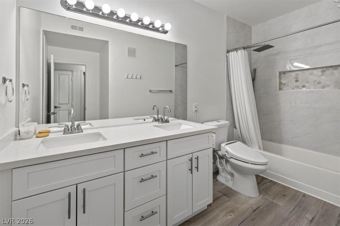 2900 Sunridge Heights Parkway, #1022, Henderson, NV 89052 A spacious double vanity and tiled tub shower combine style and utility in this bathroom.