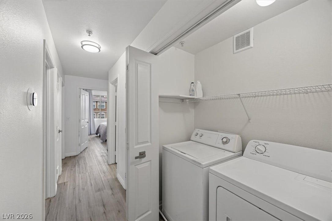 2900 Sunridge Heights Parkway, #1022, Henderson, NV 89052 An in-unit laundry area features overhead wire shelving and wood-look flooring.
