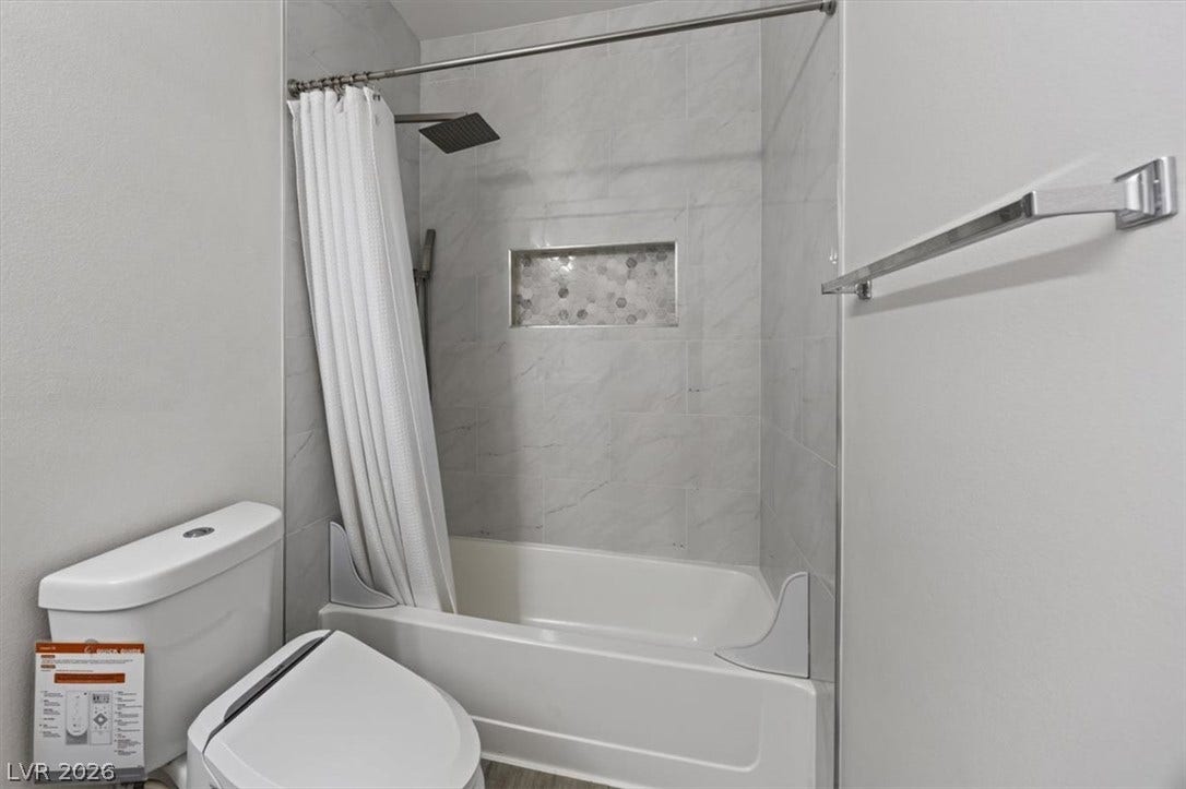 2900 Sunridge Heights Parkway, #1022, Henderson, NV 89052 Tiled tub surround with a built-in niche and modern shower fixtures.