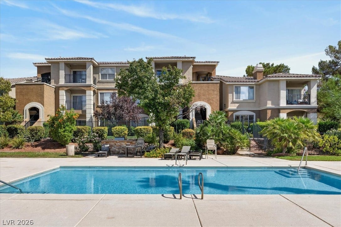 2900 Sunridge Heights Parkway, #1022, Henderson, NV 89052 A sparkling swimming pool rests before the multi-level residential building.