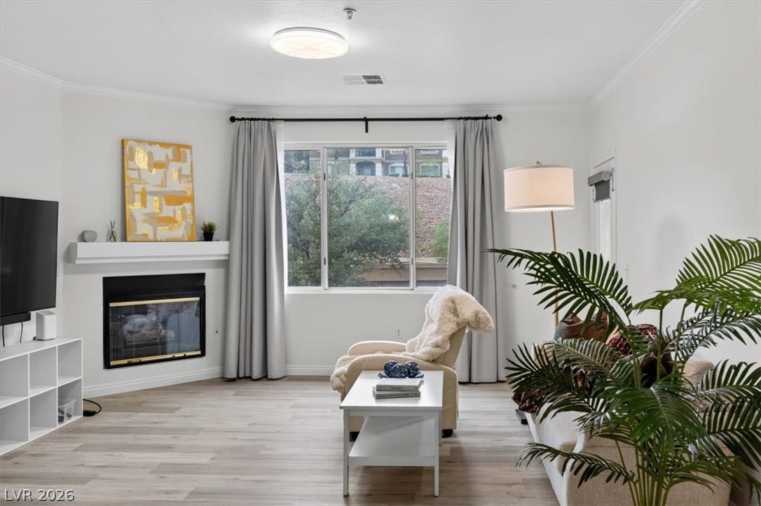 2900 Sunridge Heights Parkway, #1022, Henderson, NV 89052 A cozy fireplace anchors this inviting living space finished with durable wood-look flooring.