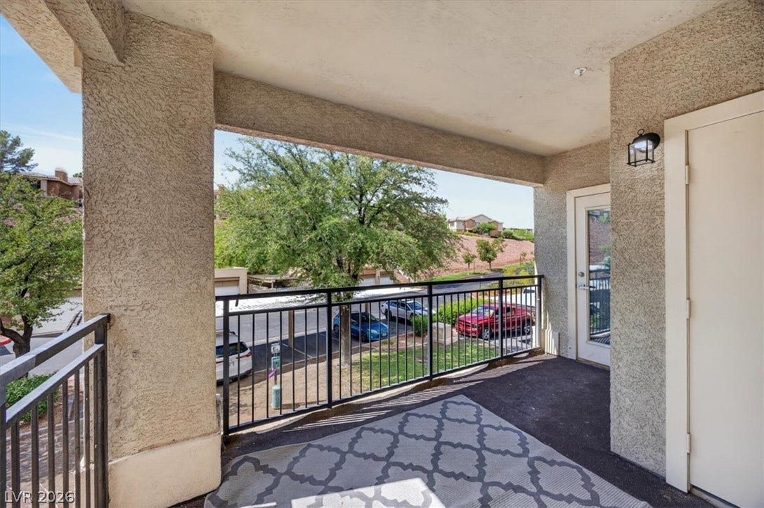 2900 Sunridge Heights Parkway, #1022, Henderson, NV 89052 Shaded concrete balcony overlooks mature neighborhood trees and open community spaces.
