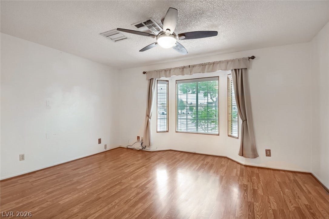 749 Tenderfoot Circle, Henderson, NV 89014 Rich wood flooring runs throughout this versatile space anchored by a classic bay window.