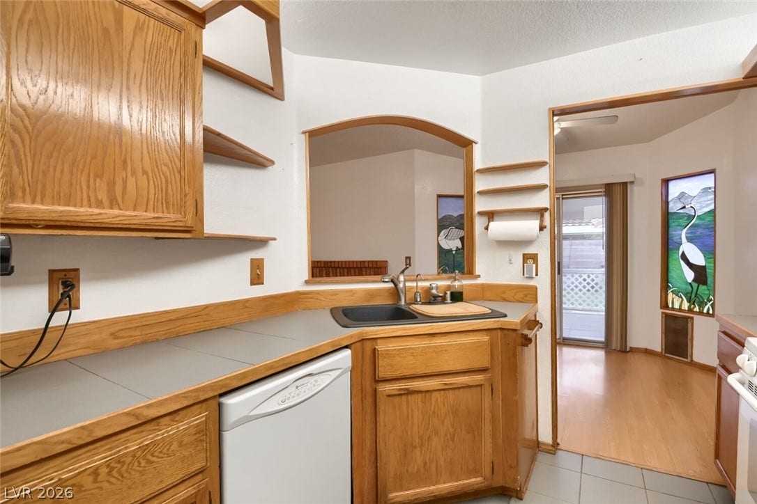 749 Tenderfoot Circle, Henderson, NV 89014 Functional kitchen spaces flow seamlessly into adjacent living areas through built-in wooden pass-throughs.