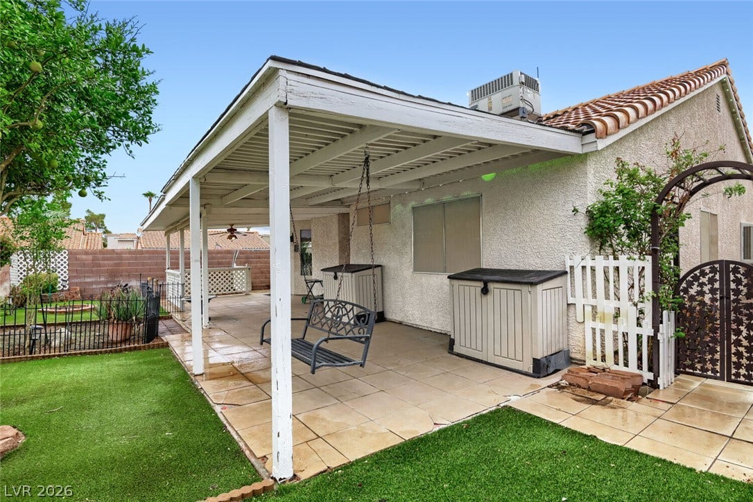 749 Tenderfoot Circle, Henderson, NV 89014 Tiled flooring and a covered patio extend along the back of this stucco home.
