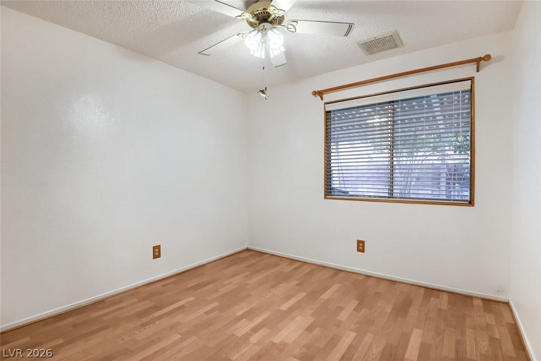 749 Tenderfoot Circle, Henderson, NV 89014 Gleaming wood floors anchor this versatile secondary bedroom space.