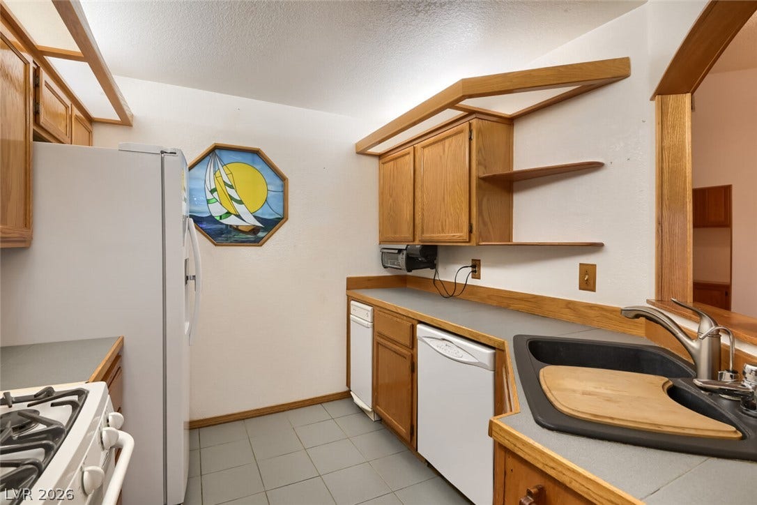 749 Tenderfoot Circle, Henderson, NV 89014 Functional kitchen spaces utilize abundant wood cabinetry and tiled flooring.
