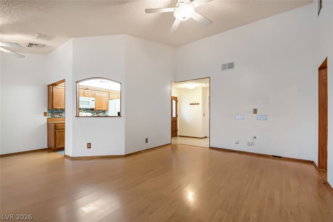 749 Tenderfoot Circle, Henderson, NV 89014 Soaring vaulted ceilings and polished wood floors define this versatile central living area.