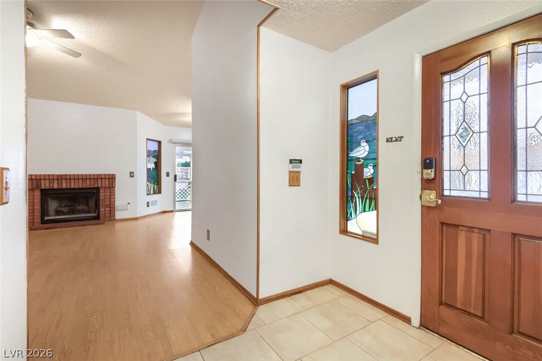 749 Tenderfoot Circle, Henderson, NV 89014 Leaded glass details and tile flooring greet guests inside this welcoming entryway.