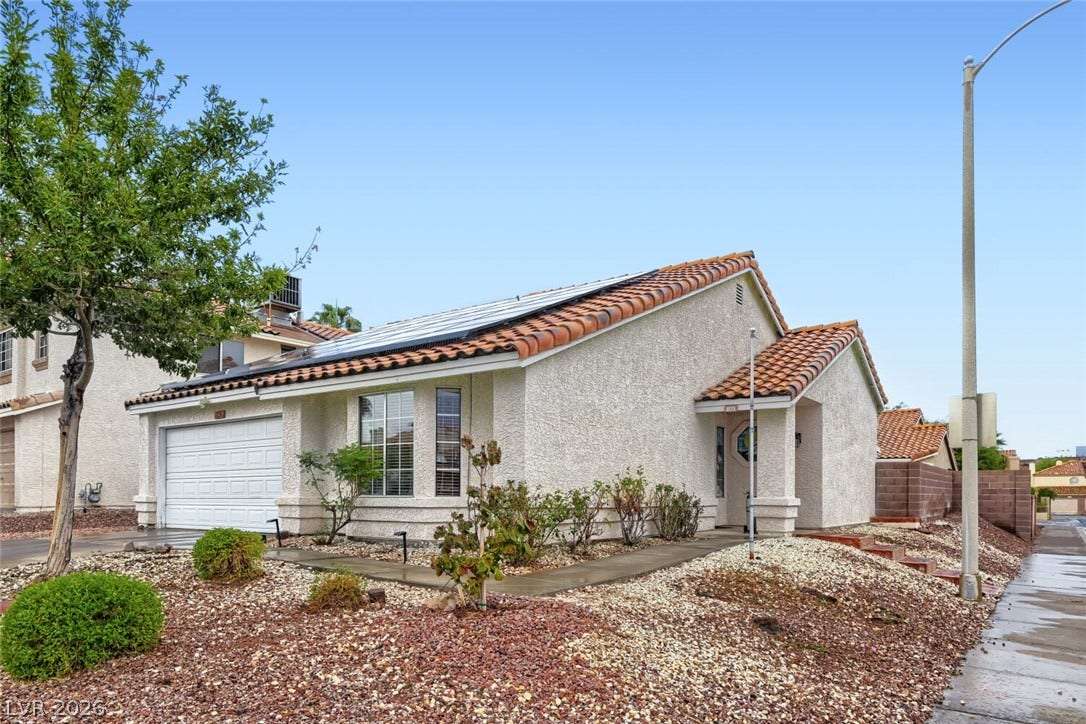 749 Tenderfoot Circle, Henderson, NV 89014 Spanish tile roofing and classic stucco exterior define this charming single-story residence.