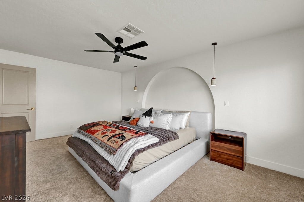 314 Encima Court, Henderson, NV 89014 A striking arched alcove creates a distinct architectural focal point above the bed area.