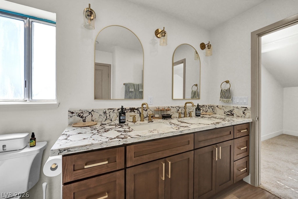 314 Encima Court, Henderson, NV 89014 Ornate stone counters and a handsome double vanity elevate this contemporary bathroom design.