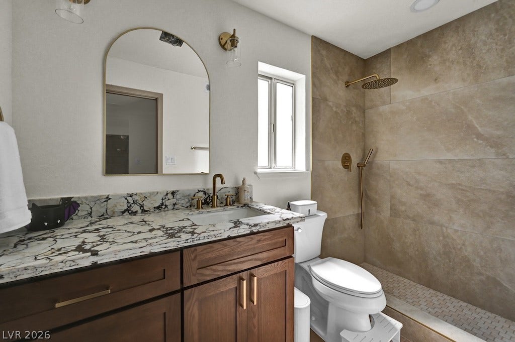 314 Encima Court, Henderson, NV 89014 Exquisite stone counters and custom tile work highlight this beautifully updated washroom.