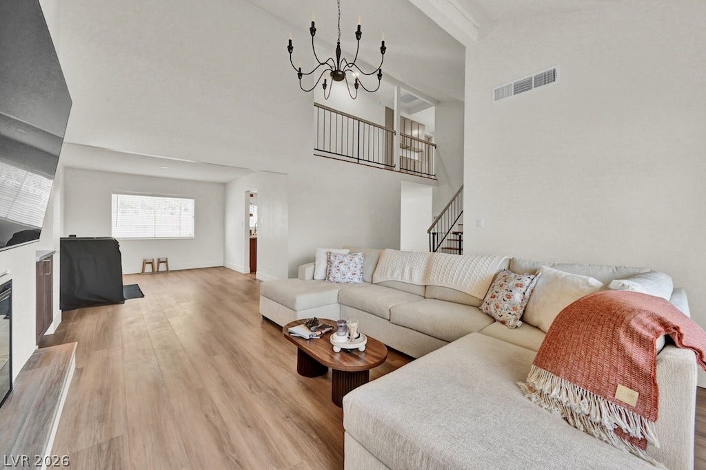 314 Encima Court, Henderson, NV 89014 An open floor plan pairs warm wood flooring with soaring vaulted ceilings and structural lines.