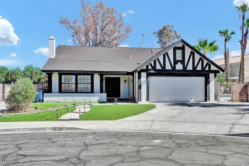 314 Encima Court, Henderson, NV 89014 Tudor-inspired accents and a sweeping driveway define this charming single-story home.