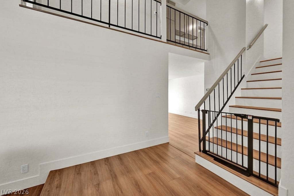 314 Encima Court, Henderson, NV 89014 Gleaming wood floors pair with a dramatic staircase underneath soaring ceilings in the entryway.