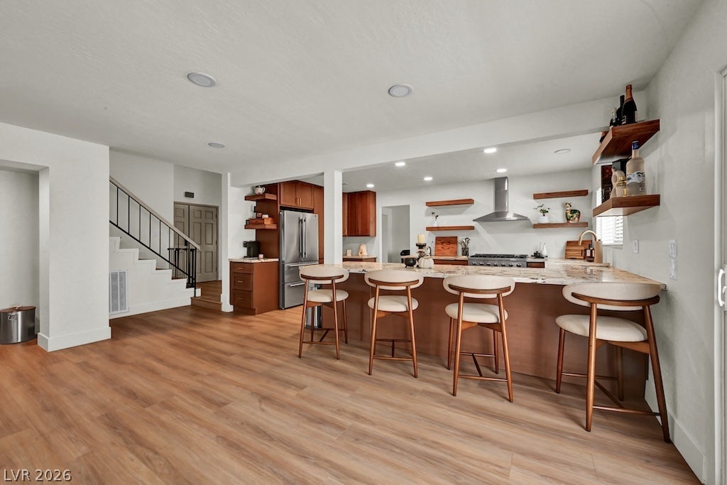 314 Encima Court, Henderson, NV 89014 An open floorplan seamlessly connects the warm wood flooring to a modern breakfast bar.