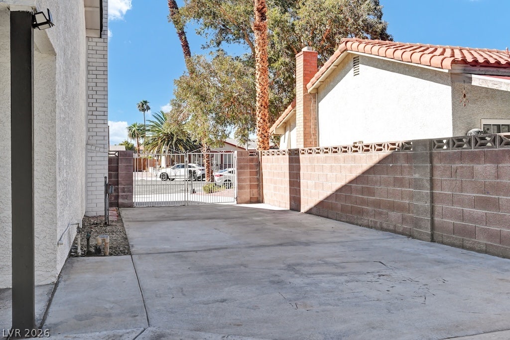 314 Encima Court, Henderson, NV 89014 A spacious concrete driveway area is enclosed by a secure block wall and gated entry.
