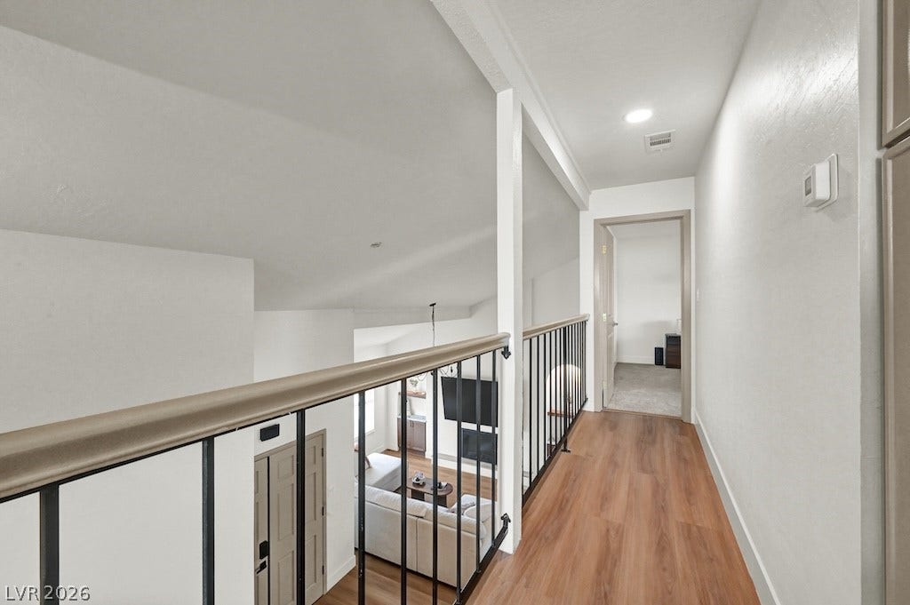 314 Encima Court, Henderson, NV 89014 An upper-level hallway overlooks the living room below through elegant wrought iron railings.