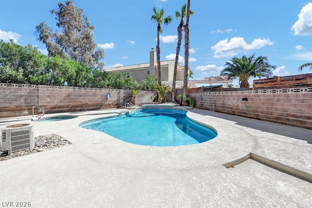 314 Encima Court, Henderson, NV 89014 An inviting backyard oasis features a sparkling in-ground pool surrounded by private brick walls.