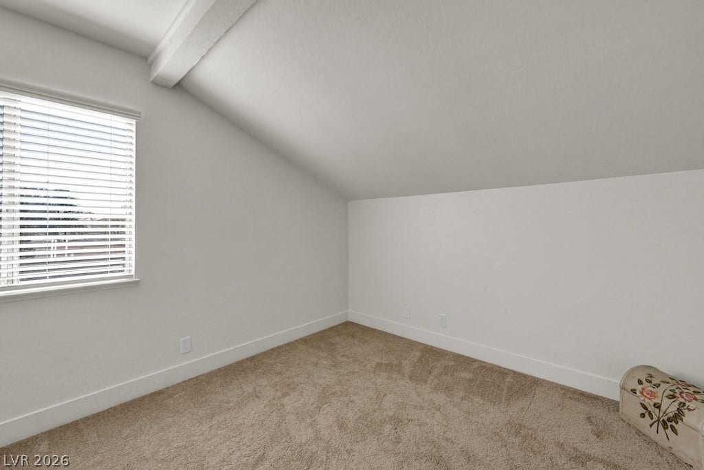314 Encima Court, Henderson, NV 89014 A sloped ceiling and wall-to-wall carpeting define this cozy second-story room.