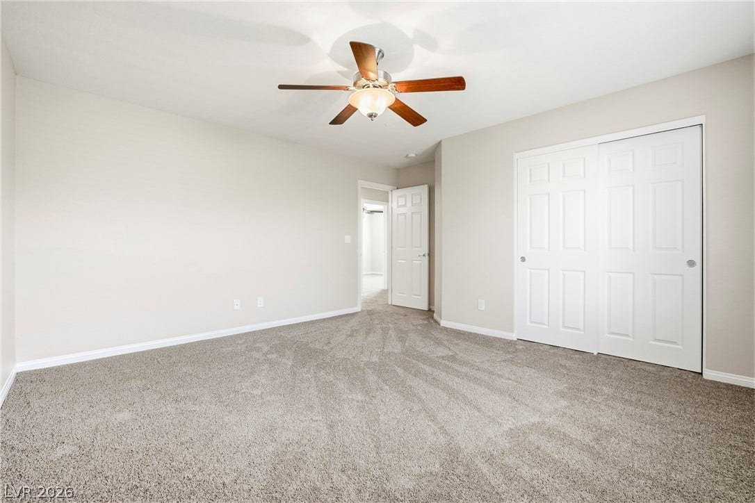 2221 Mundare Drive, Henderson, NV 89002 Plush carpeting and crisp white baseboards frame a versatile second-floor bedroom layout.