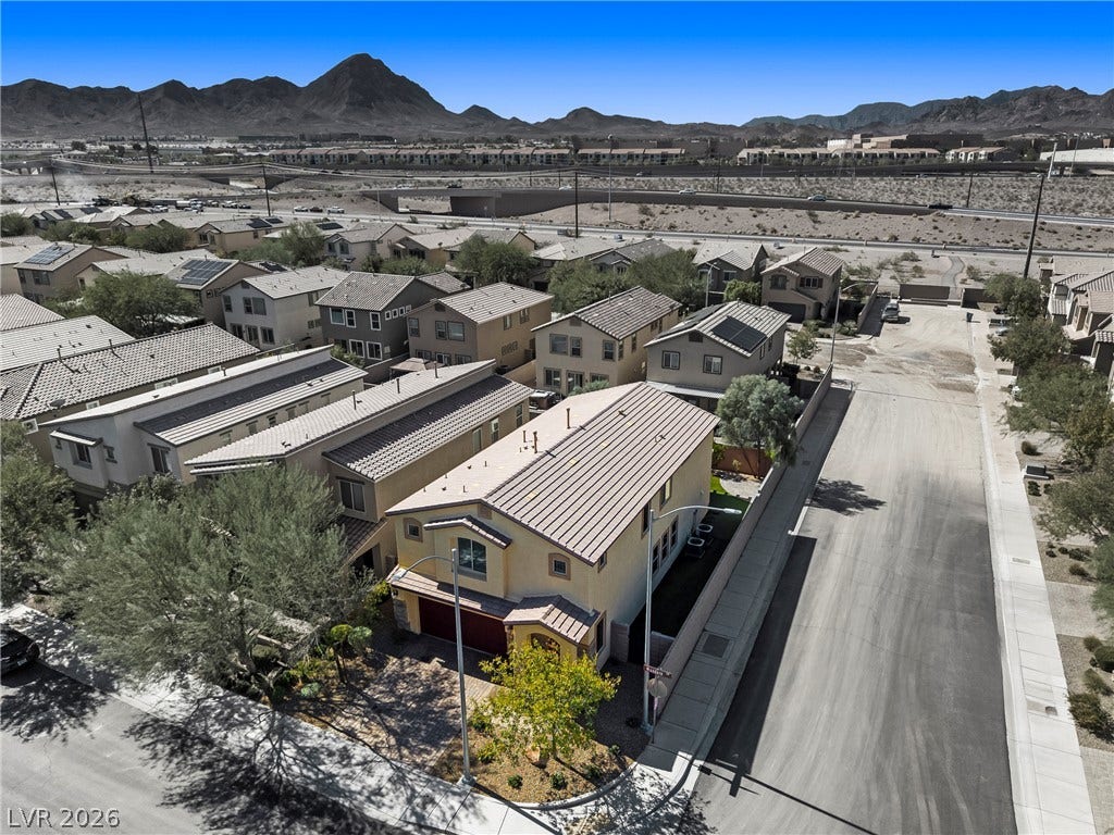 2221 Mundare Drive, Henderson, NV 89002 An elevated perspective showcases the neighborhood's tiled roofs set against a dramatic mountain backdrop.