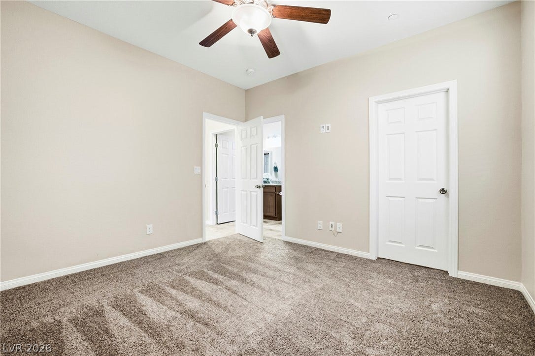 2221 Mundare Drive, Henderson, NV 89002 Plush carpeting and neutral-toned walls create a peaceful and inviting atmosphere.