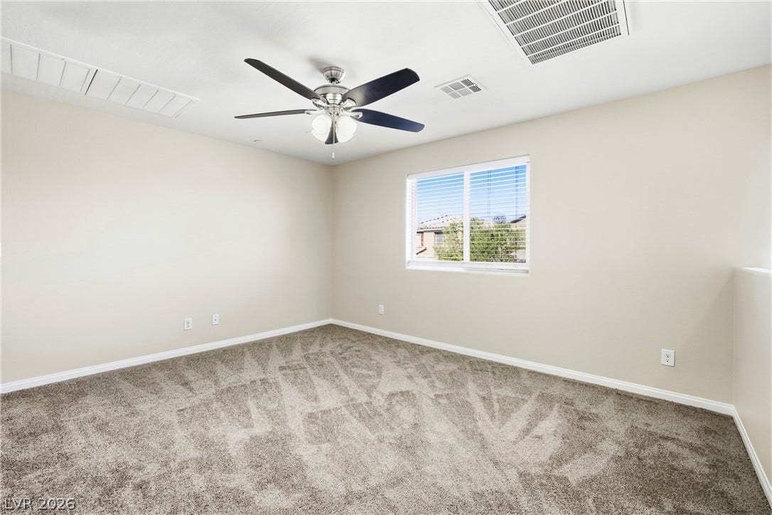 2221 Mundare Drive, Henderson, NV 89002 Plush carpeting and a wide window create a comfortable and welcoming atmosphere.