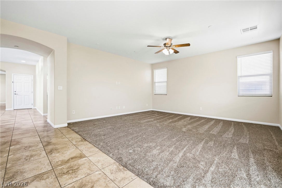 2221 Mundare Drive, Henderson, NV 89002 Plush carpeting meets durable tile flooring in this open living area with arched entryways.