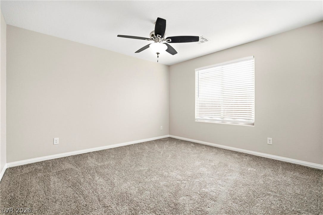 2221 Mundare Drive, Henderson, NV 89002 Plush carpeting and a large window create a comfortable and welcoming atmosphere.