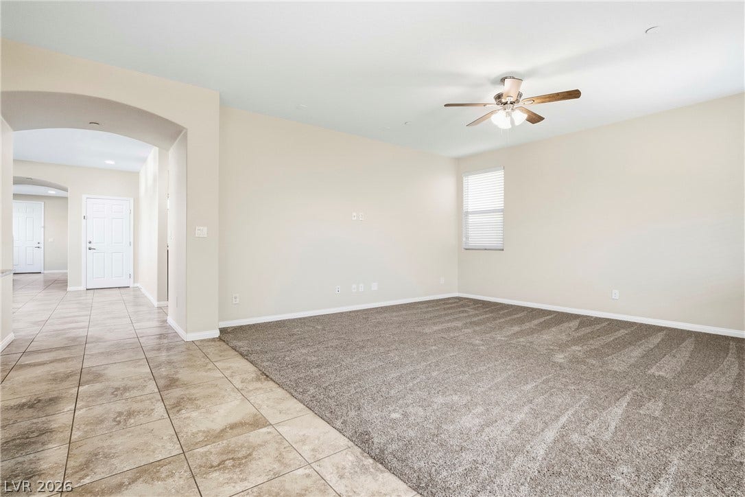 2221 Mundare Drive, Henderson, NV 89002 Plush carpeting and an arched transition flow seamlessly into the adjacent tiled entryway.