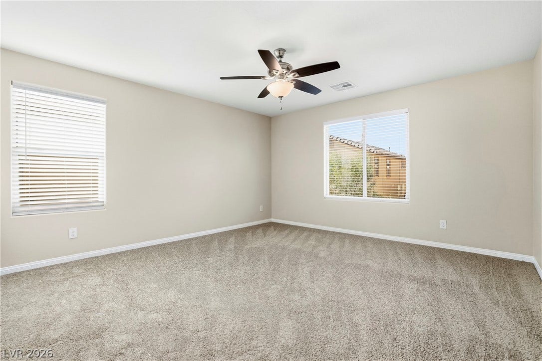 2221 Mundare Drive, Henderson, NV 89002 Generous natural light fills this versatile space finished with neutral walls and soft carpeting.