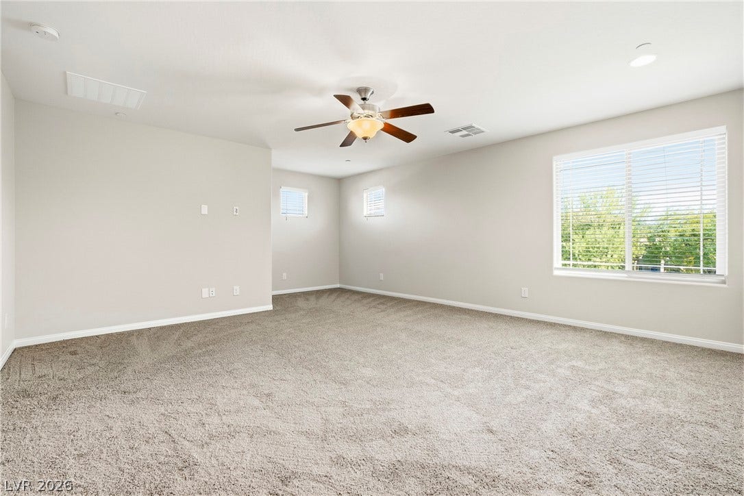 2221 Mundare Drive, Henderson, NV 89002 Plentiful windows fill this carpeted living space with natural light.
