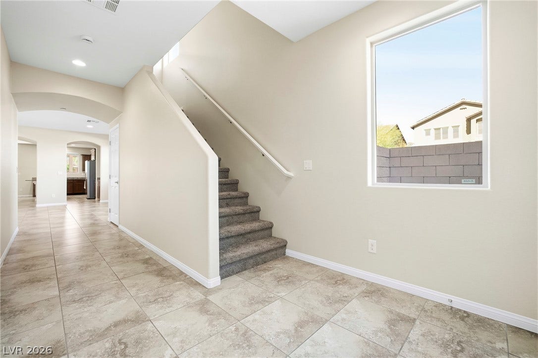 2221 Mundare Drive, Henderson, NV 89002 Tiled floors and a carpeted staircase anchor this airy entry hall with high ceilings.