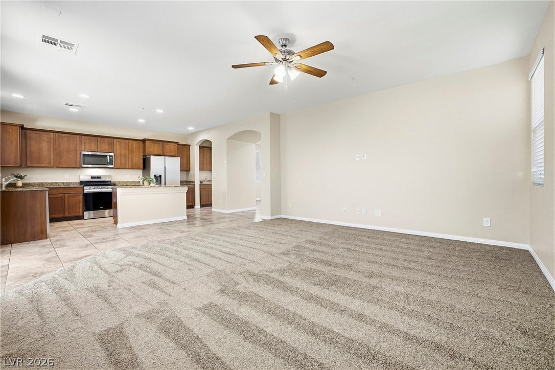 2221 Mundare Drive, Henderson, NV 89002 An open floor plan seamlessly connects the carpeted living area to the tiled kitchen.