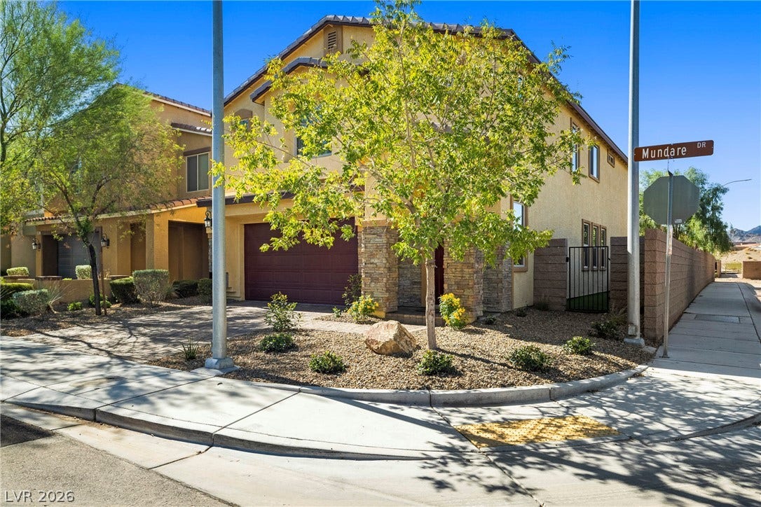 2221 Mundare Drive, Henderson, NV 89002 Stone accents and desert landscaping enhance this two-story corner lot residence.