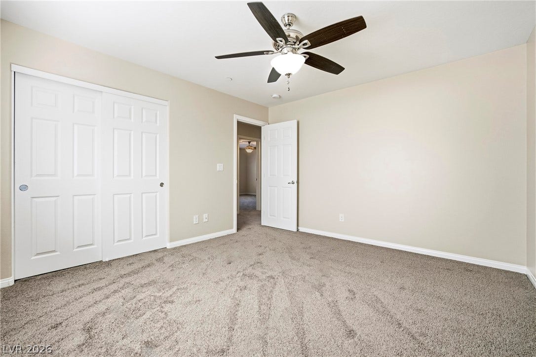 2221 Mundare Drive, Henderson, NV 89002 Plush wall-to-wall carpeting and clean neutral walls anchor this versatile private bedroom.