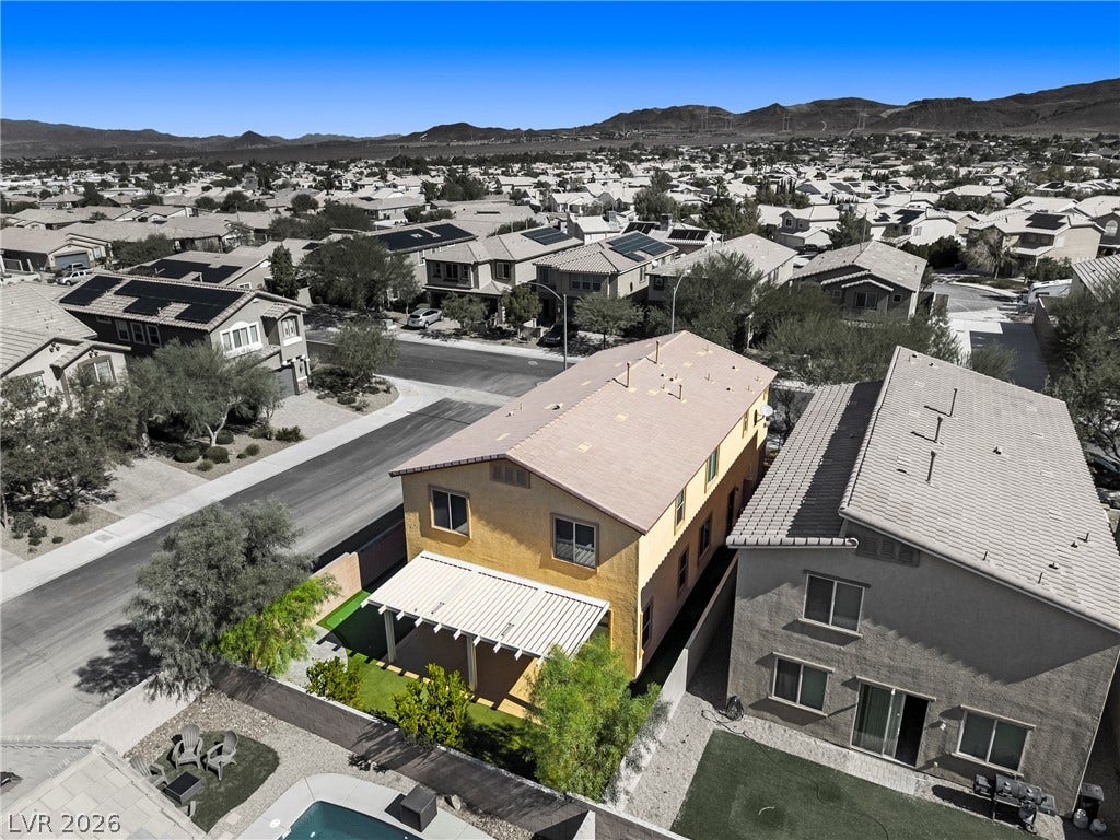 2221 Mundare Drive, Henderson, NV 89002 Distant mountain ranges frame a neighborhood view surrounding this two-story residential structure.