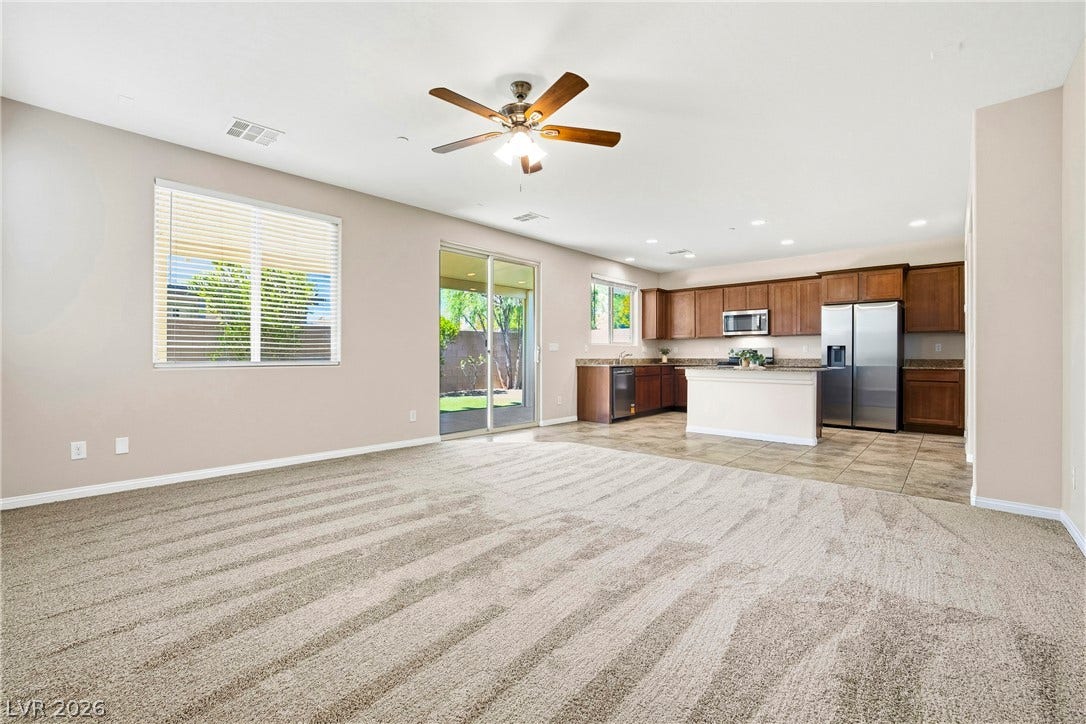 2221 Mundare Drive, Henderson, NV 89002 An open floorplan seamlessly connects the carpeted living area to the tiled kitchen.